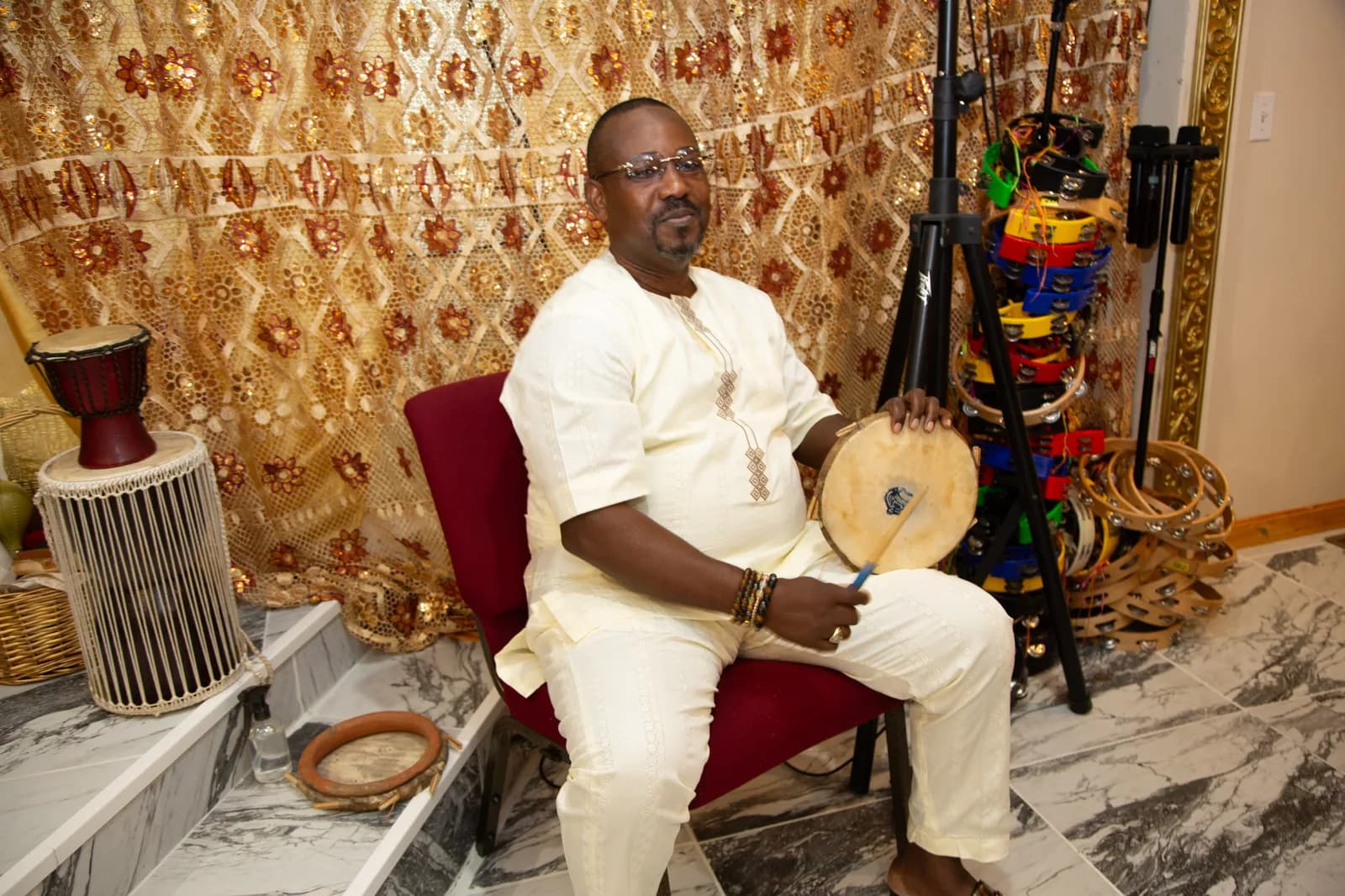 Musician with traditional hand drum among the percussion section