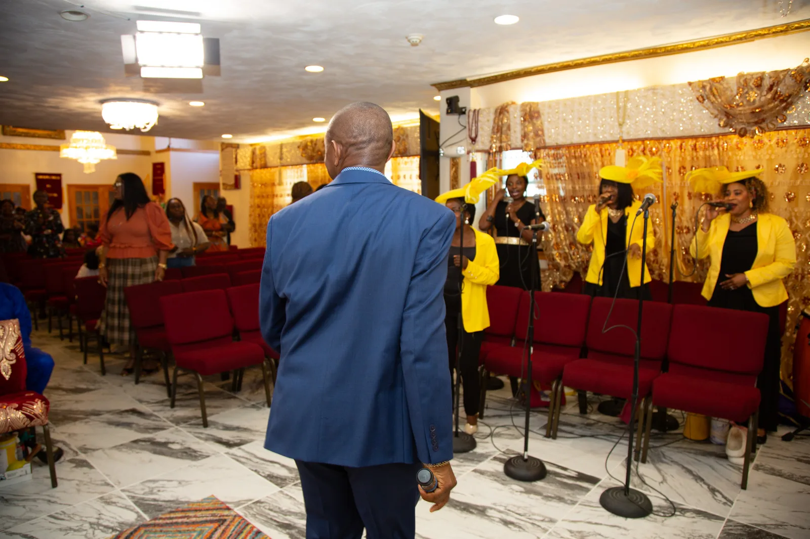View from behind the host toward the choir — full decorated sanctuary in frame