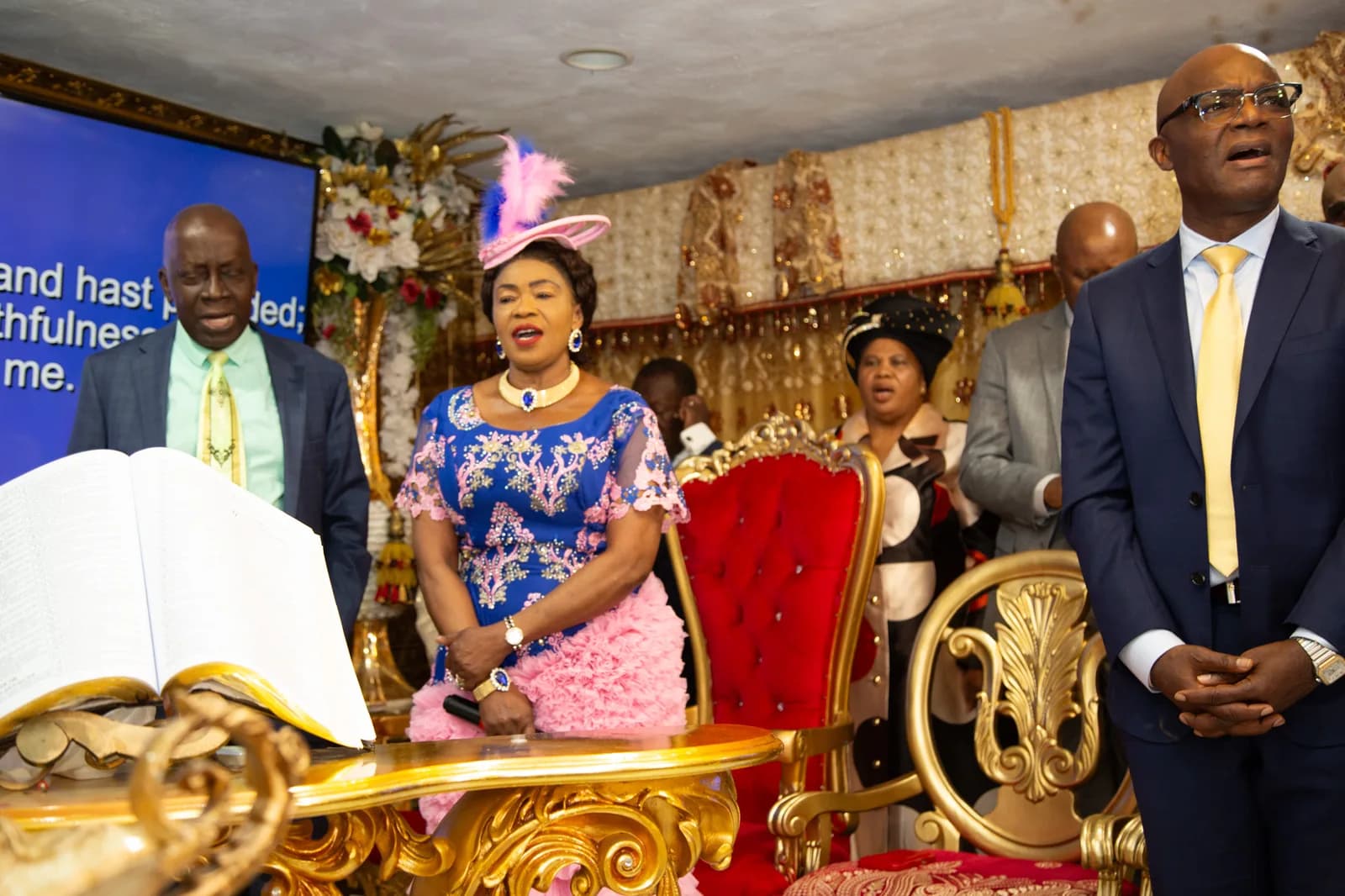 Female leader at the platform with open Bible — leadership in worship