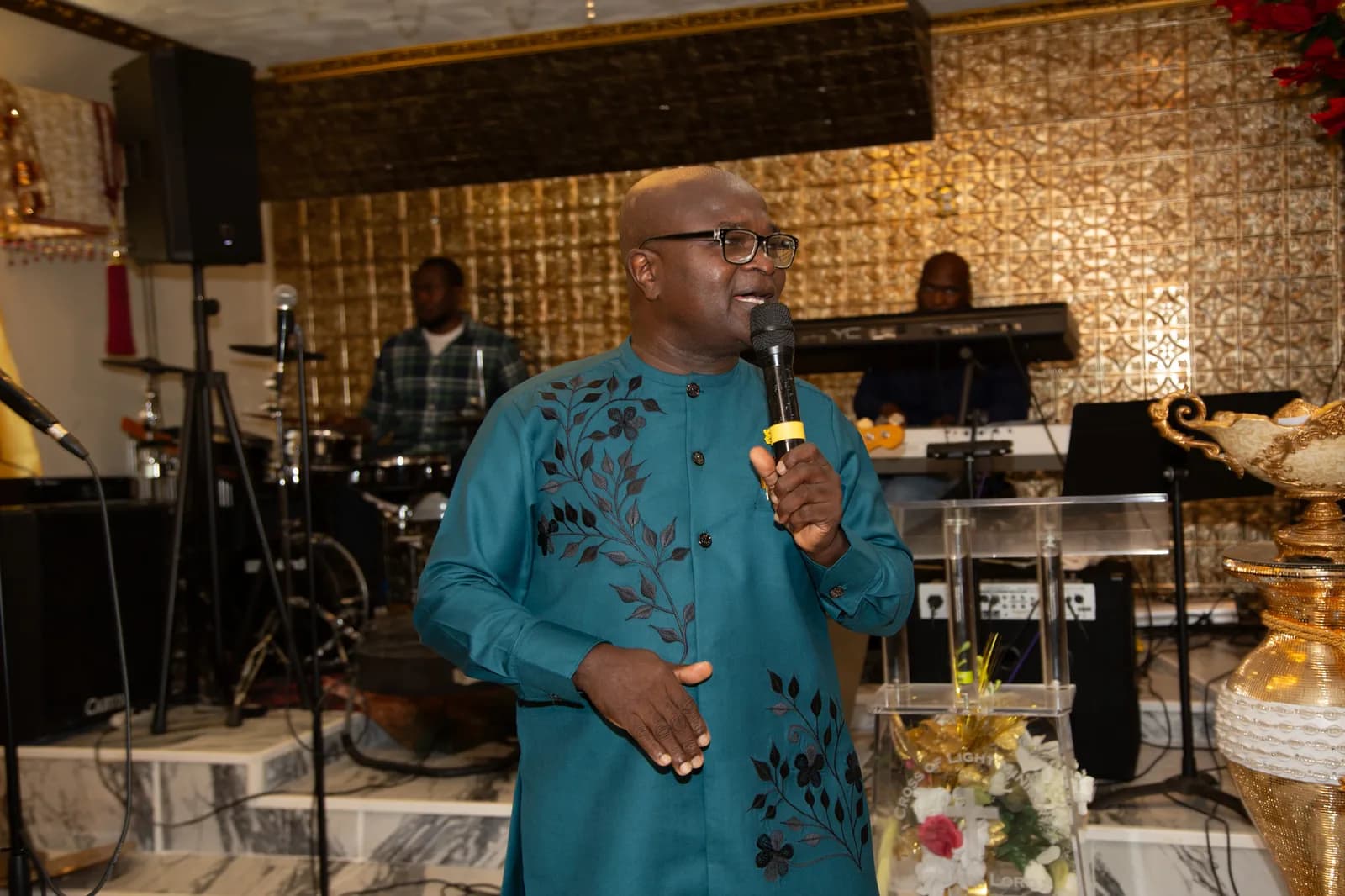 Pastor speaks warmly to the congregation with the full band behind him