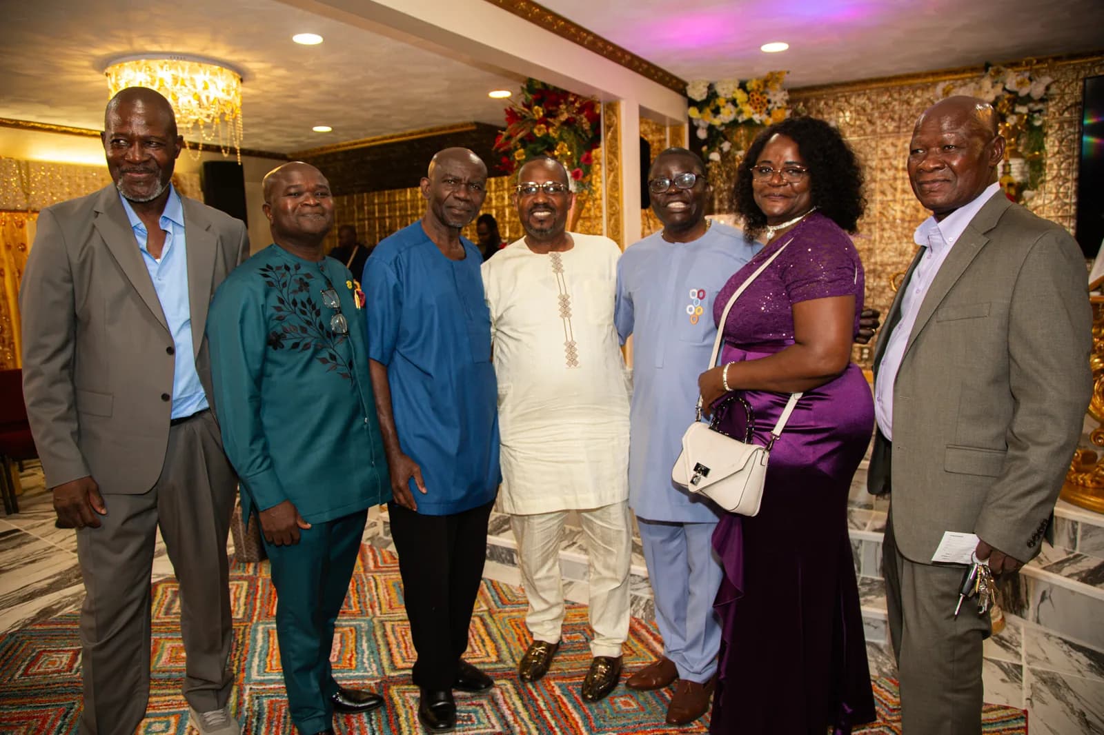 Large smiling group dressed in their finest for the celebration